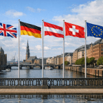 British, German, Austrian, Swiss and EU flags flying on a bridge